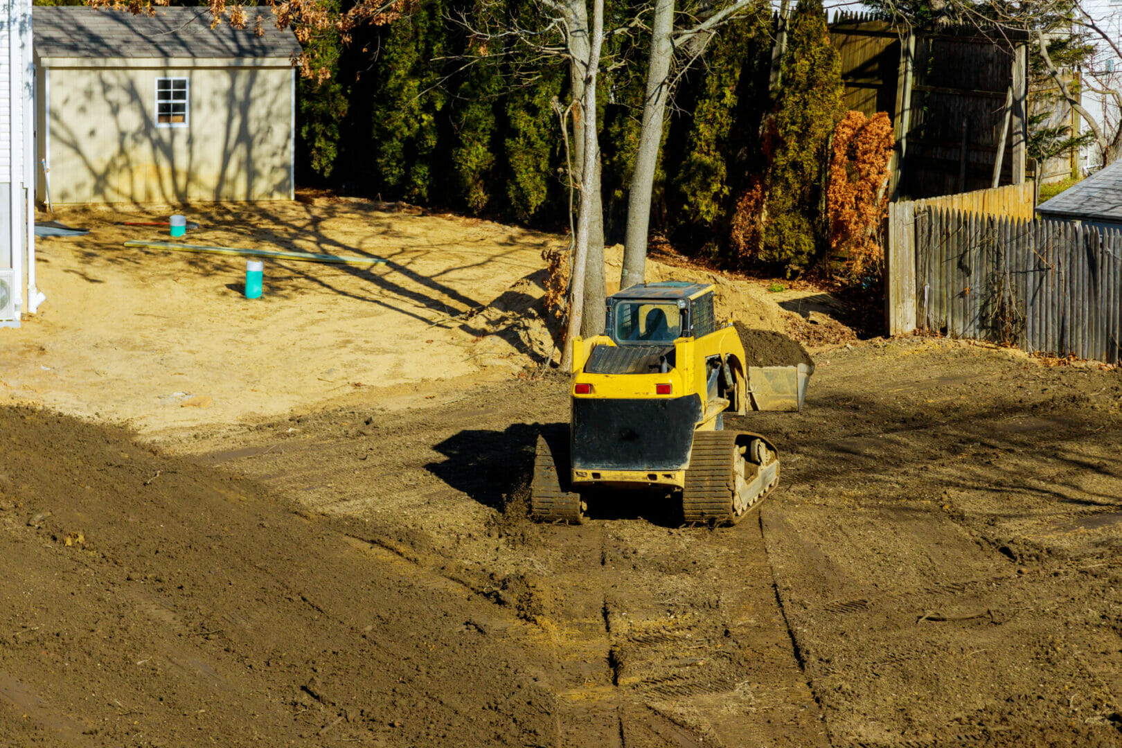 Small tractor digging land working with land level the ground